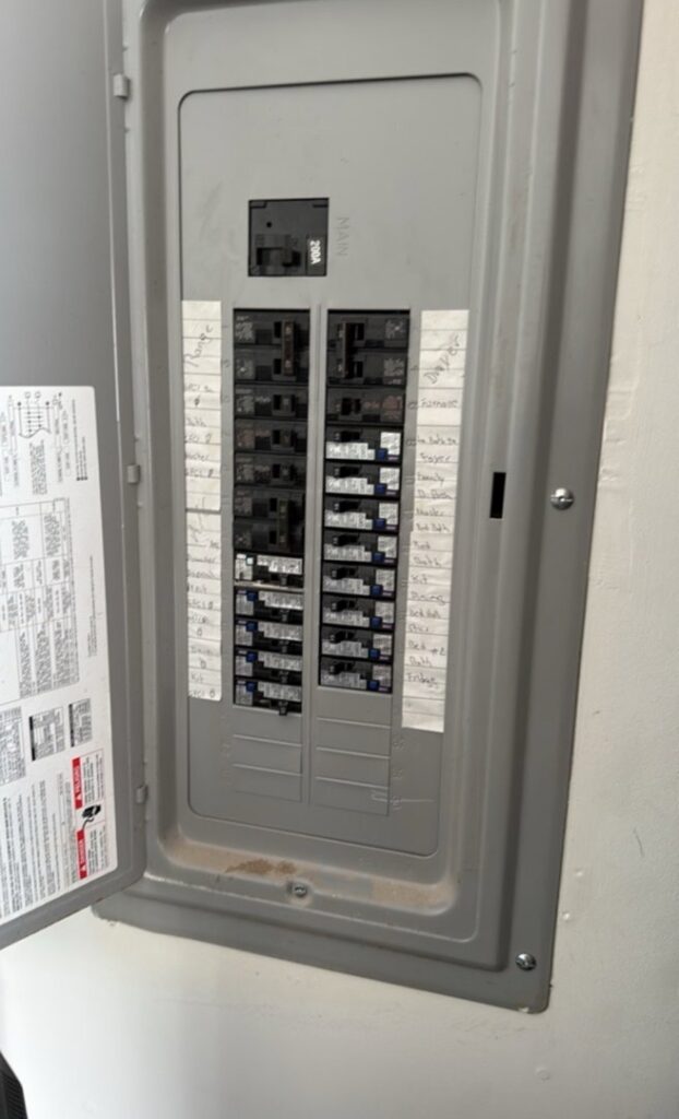 An open electrical panel displaying labeled circuit breakers, serviced by Geter Electrical Services LLC in Fountain Inn, SC.