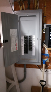 An open electrical panel with labeled breakers, showing electrical work by Benoit Electrical Services in Litchfield, NH.