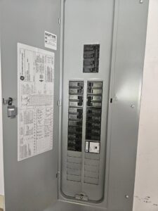 An open electrical panel with circuit breakers and wiring, inspected by Crawford Electric Services, LLC in Kings Mountain, NC.