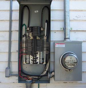 An open electrical panel and utility meter on a house exterior, showing expert electrical service from MSMB Maintenance in Greenville, SC.