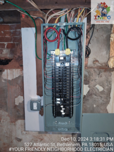 An open electrical panel showing complex wiring and circuit breakers serviced by Imecpower in Bethlehem, PA.