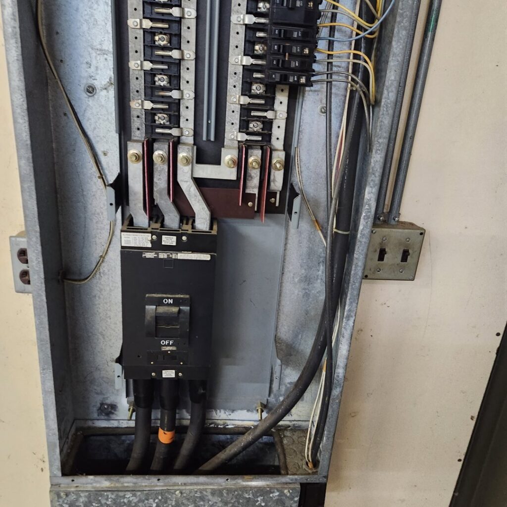 An open electrical panel showing breakers and wiring during an inspection by Tim Lambert Electric in Fayetteville, NC.
