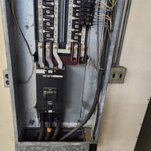 An open electrical panel showing breakers and wiring during an inspection by Tim Lambert Electric in Fayetteville, NC.