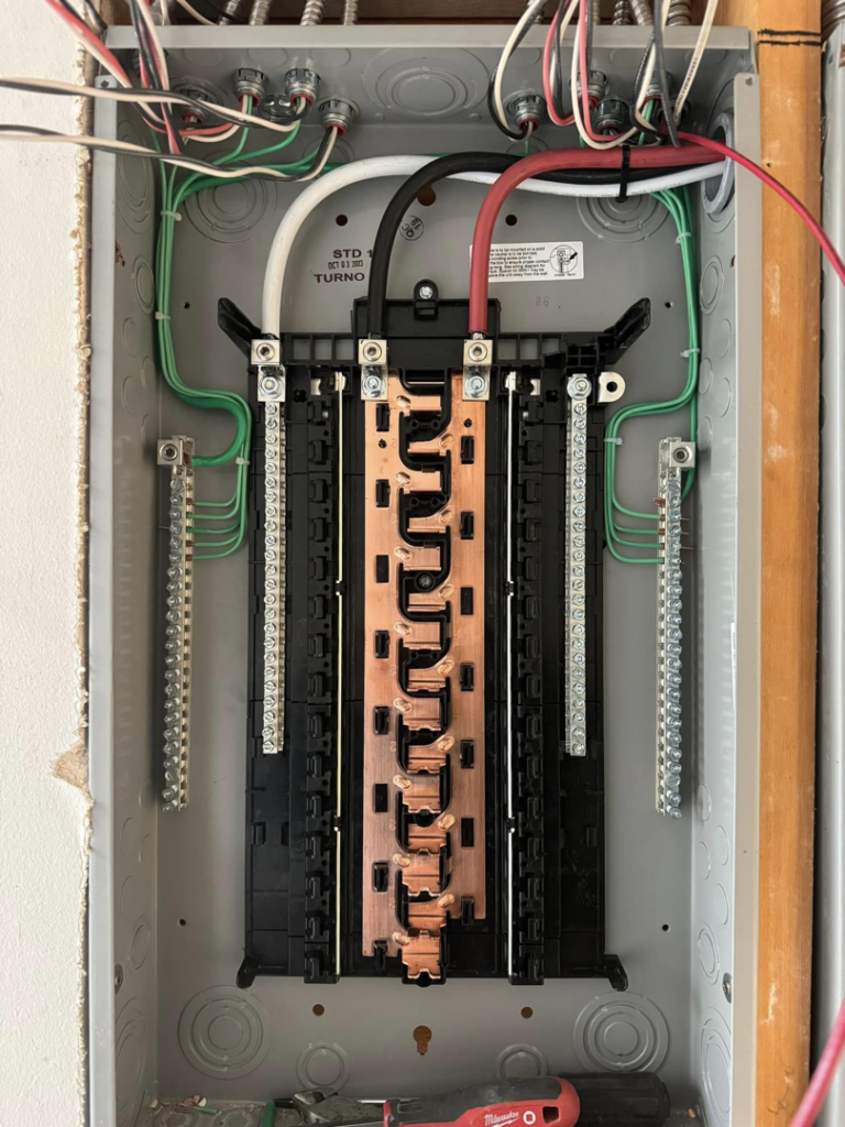 An open electrical panel showing bus bars and wiring during an installation or service by LN Electrical in Coeur D Alene, ID