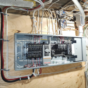 An open electrical panel showing circuit breakers and complex wiring, expertly handled by SEL Electric in Truro, NS.