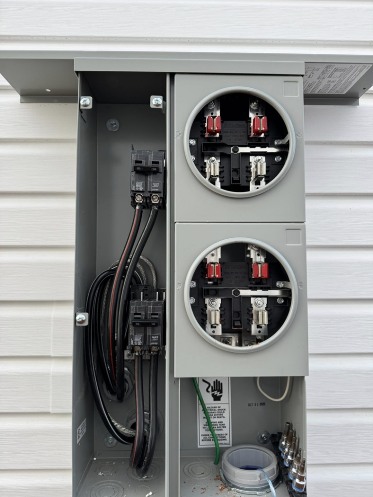 A close-up view of an open electrical panel with wiring and circuit breakers, showcasing expert work by Stricklen Electrical Industries LLC in Clarksville, TN.