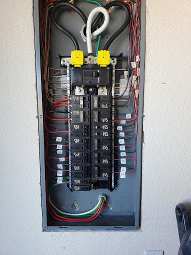 An open electrical panel with visible wiring and circuit breakers by True Light Electric in Albuquerque, NM.