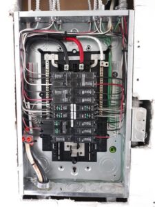 An open electrical panel with circuit breakers and wiring, serviced by Electricians On Call in Fort Lauderdale, FL.