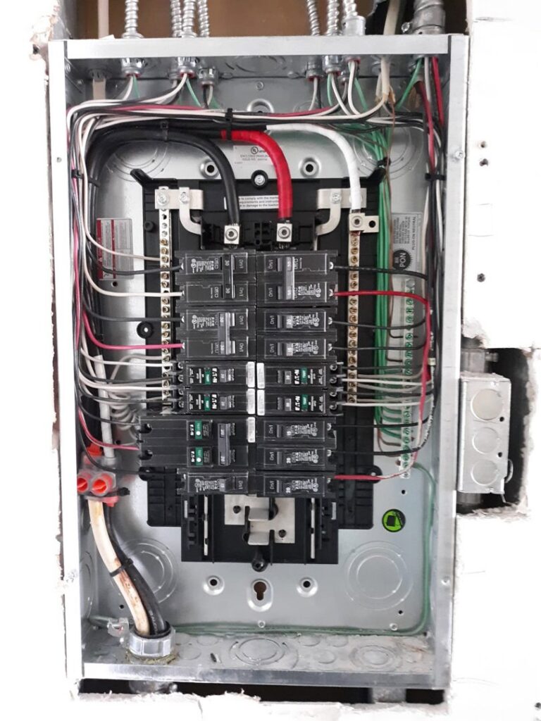 An open electrical panel with circuit breakers and wiring, serviced by Electricians On Call in Fort Lauderdale, FL.