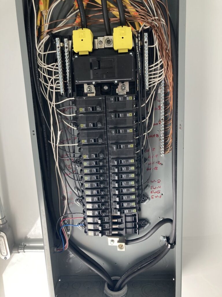 An open electrical panel showing numerous wires and circuit breakers, indicating electrical service by Diaz Techician LLC in Chicago, IL.