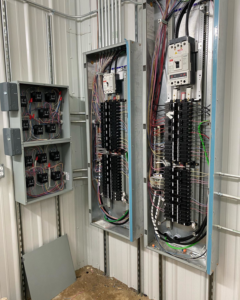 Open electrical panels and control boxes with wiring and conduits installed by Tallent Electrical Services in Tulsa, OK