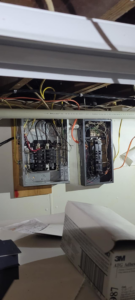 Two open electrical panels with visible wiring and circuit breakers, indicating electrical service work by Benson Electric LLC in Owensboro, KY.
