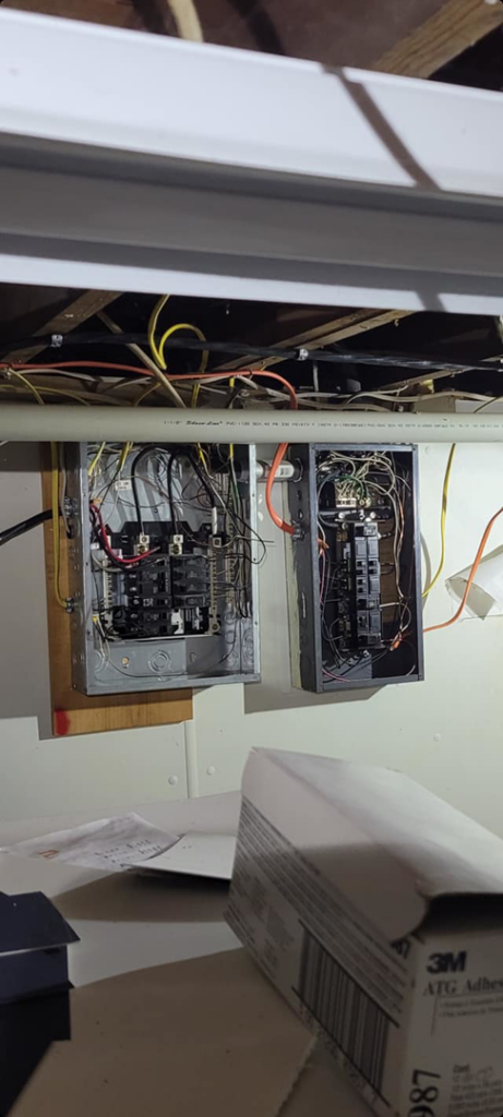 Two open electrical panels with visible wiring and circuit breakers, indicating electrical service work by Benson Electric LLC in Owensboro, KY.