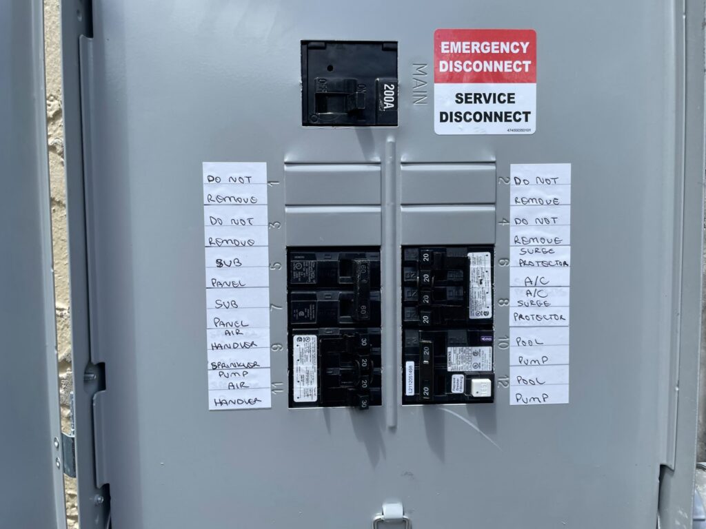 An open electrical service disconnect panel with circuit labels, indicating work by MG ELECTRIC INC in Lauderhill, FL