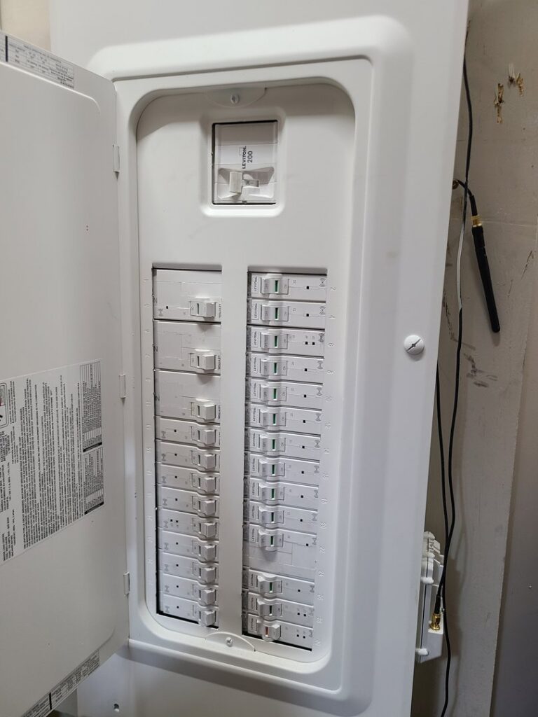 An open electrical service panel displaying numerous circuit breakers, indicating professional electrical work by 8Thirty Electric, Inc. in Johns Creek, GA.