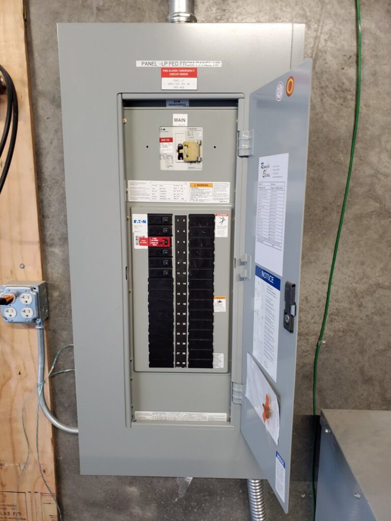 An open electrical service panel showing circuit breakers and wiring, installed by TJS Electrical Services Inc in Mesa, AZ.