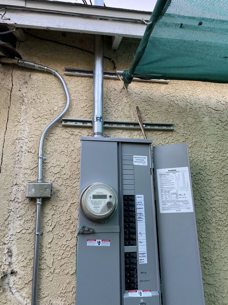 An open exterior electrical panel showing circuit breakers, indicating service by CLB Electric Corporation in Norwalk, CA