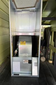 An open furnace or air handler unit showing internal components, serviced by Best Heat & Air in Tacoma, WA.