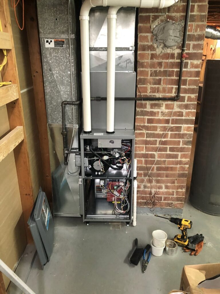 An open furnace unit with exposed components during service or installation by Ohio City Heating and Cooling in Cleveland, OH.