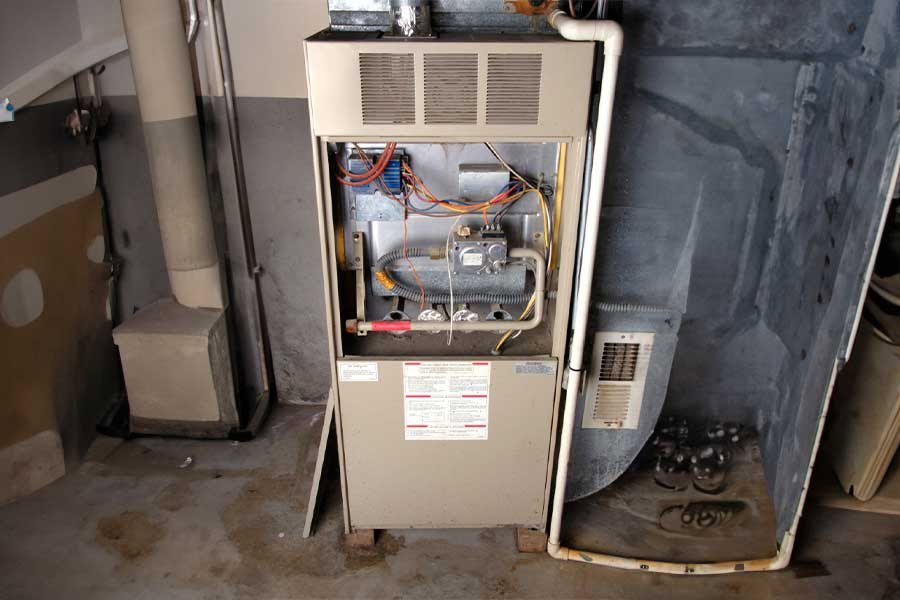 An open furnace unit revealing its internal components, indicating maintenance or repair by NorthStar Services in South Haven, MN