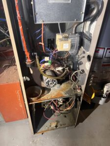 An open furnace unit showing internal components, indicating repair or maintenance by T. D'Albora Heating and Cooling in Erie, PA.