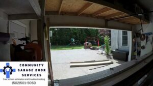 An open garage door providing a view to a backyard, indicating a functional garage door installed or repaired by Community Garage Door Services in Louisville, KY.