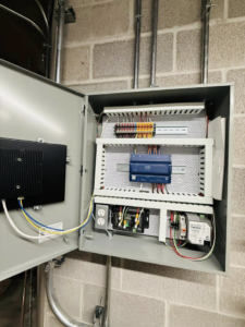 An open HVAC control cabinet showing intricate wiring and components by ICM Mechanical & Controls, LLC in Fall River, MA