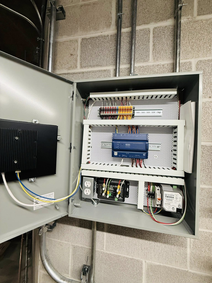 An open HVAC control cabinet showing intricate wiring and components by ICM Mechanical & Controls, LLC in Fall River, MA
