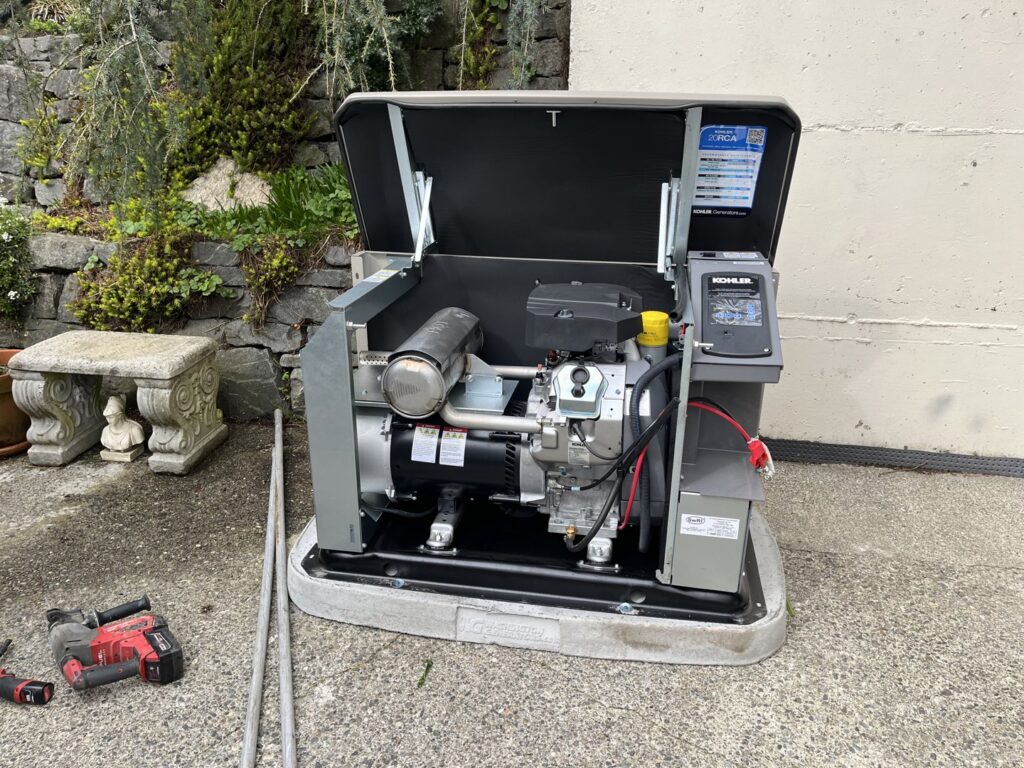 An open Kohler generator showing the engine and internal components during service by Washington Generators LLC in Kent, WA.