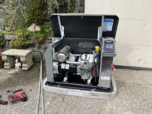 An open Kohler generator showing the engine and internal components during service by Washington Generators LLC in Kent, WA.