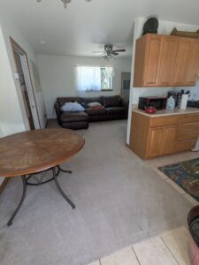 An open-plan living area with a freshly cleaned carpet by Alamogordo Carpet Cleaning in Alamogordo, NM.