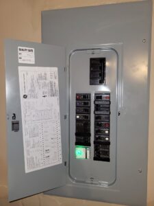 An open residential electrical breaker panel showing circuit breakers, serviced by Ozzy Electric in Jacksonville, FL.
