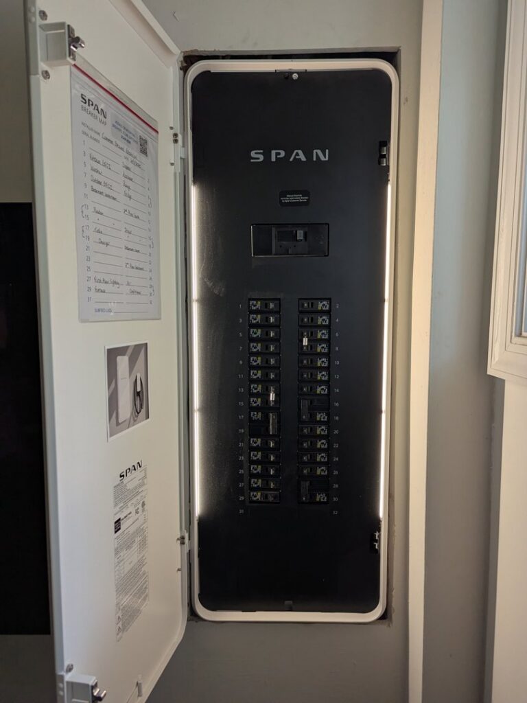 An open SPAN smart electrical panel showing circuit breakers, installed by Common Ground Electrical in Baltimore, MD.