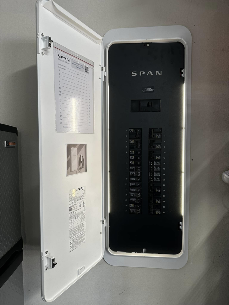 An open SPAN smart electrical panel revealing its circuit breakers and internal components, installed by Volt-Pro Electric, LLC in Houston, TX