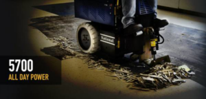 An operator using a ride-on floor removal machine, clearing old flooring at Clean Site Flooring Removal in Sacramento, CA.
