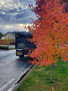 An OregonScapes branded work truck parked next to a well-maintained lawn, ready for professional lawn care in Eugene, OR.