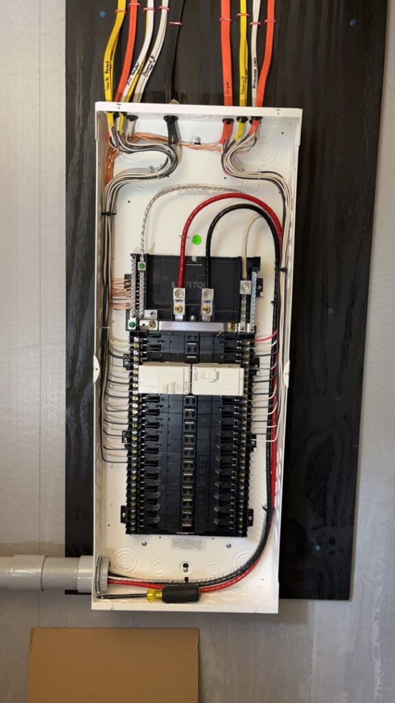 An open electrical breaker panel showing neatly organized wiring by Josh LaFerriere Electric in Westbrook, ME.