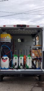 Organized pest control equipment, including multiple sprayers, visible in the back of a service van for Spectrum Pest Control Eco-Tech LLC in Kenosha, WI.
