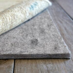 An organized interior view of the rug store, displaying stacked and rolled rugs at American Rug Laundry in Saint Paul, MN.