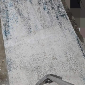 An oriental rug being professionally cleaned, showing a clear before and after difference by Hopman Rug Cleaners in Hammond, IN.