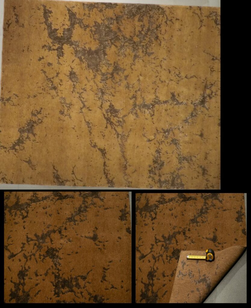 A vibrant display of oriental rugs on walls and rolled on the floor in the showroom of Ebie's Rug Cache & Ebie's Rug Cleaning in Tucson, AZ