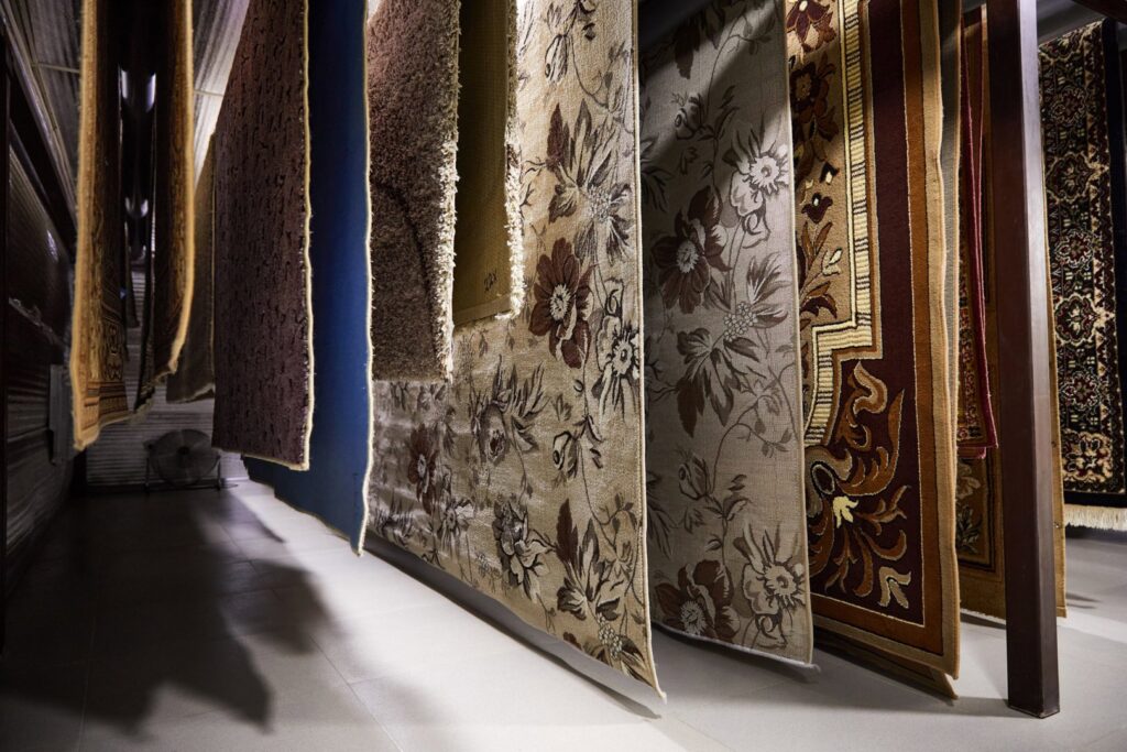 Various oriental rugs hanging to dry in a professional cleaning facility at Alexandria Green Carpet & Rug Cleaning in Alexandria, VA.