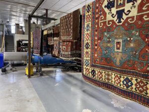 Several oriental rugs hanging to air dry in the facility of Renaissance Rug Cleaning Inc. in Portland, OR.