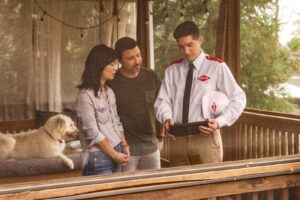 An Orkin Pest Control technician consulting with homeowners on their porch in Jonesboro, AR, discussing pest control solutions.
