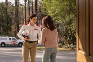 An Orkin Pest Control technician greeting a customer outside their home in Jonesboro, AR, before starting a service.