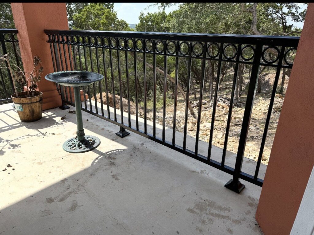 An ornamental iron balcony railing providing safety and style, installed by Superior Fence Co. of San Antonio, TX.
