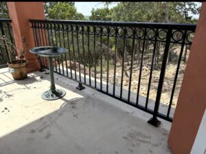 An ornamental iron balcony railing providing safety and style, installed by Superior Fence Co. of San Antonio, TX.