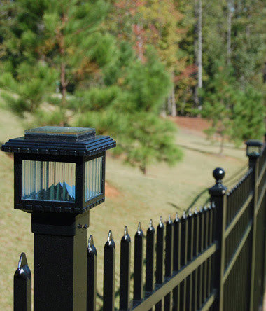 A close-up of an ornamental iron fence post with a solar light cap by D-Fence of Tulsa in Tulsa, OK.