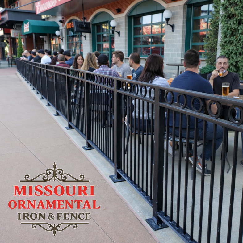 An ornamental iron fence separating a restaurant patio from the sidewalk in St Louis, MO, installed by Missouri Ornamental Iron and Fence.