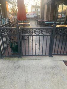 An ornamental metal fence enclosing a commercial patio seating area by America's Fencing in Nashville, TN.